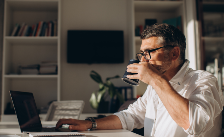 Man met koffie en laptop